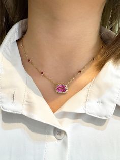 GRS certified 5.10 carat no heat cushion cut Ceylon origin pink sapphire necklace. The pink sapphire is prong set in 18k yellow gold and encompassed by 20 round cut diamonds that total 0.46 carats. On the chain of the necklace are 8 round cut rubies bezel set in 18k yellow gold.  Details:  ✔ Item type: Floating pendant necklace ✔ Metal: 18k yellow gold ✔ Weight: 4.89 grams ✔ Setting: bezel, prong  ✔ Length: 18 Inches Stone Details: ✔ Gemstone: Sapphire ✔ Carat: 5.10  ✔ Color: Pink ✔ Cut: Cushion Luxury Elegant Pink Sapphire Necklaces, Luxury Pink Sapphire Gemstone Necklace, Luxury Pink Gold Pink Sapphire Necklaces, Luxury Cushion Cut Gemstone Necklace, Pink Ruby Necklace Fine Jewelry, Luxury Pink Ruby Necklaces, Pink Ruby Necklace For Formal Occasions, Formal Pink Necklaces With Gemstone Accents, Formal Pink Gemstone Accented Necklaces