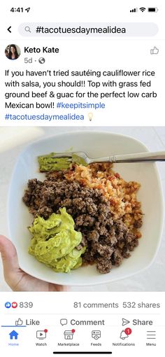 a person holding a plate of food with guacamole and meat on it