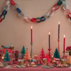 a table topped with lots of plates and candles