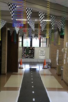 a school hallway decorated with checkered flags and streamers