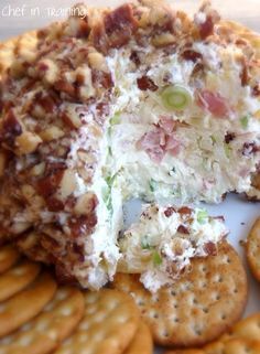 a cheese ball with crackers and grapes on it