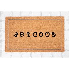 a door mat with the word goodbye written in black ink on white and tan checkered fabric