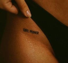 a girl power tattoo is shown on the side of her arm and it says girl power