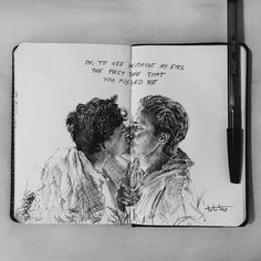 an open notebook with a drawing of two people kissing each other and the words on it