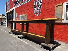 a bench sitting in front of a red brick building with the words us customs on it