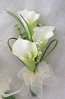 two white flowers with green stems and ribbons