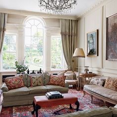 a living room filled with furniture and a chandelier