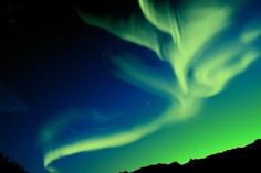 an aurora bore is seen in the night sky