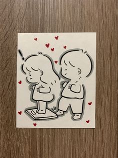 a sticker depicting two children kissing each other with hearts on the floor behind them