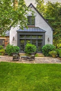 a house that is surrounded by trees and grass