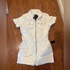 Brand New Never Worn Before White Denim Romper. Front Zipper, Stretchy Waist, Overall Comfortable Stretch Fabric. Does Have A Slight Stain On The Left Pocket (See Pictures) From Being In Storage. White Denim Jumpsuit With Pockets, Trendy White Denim Jumpsuit With Pockets, Trendy White Relaxed Fit Jumpsuits And Rompers, Trendy White Cotton Denim Jumpsuit, Trendy White Denim Jumpsuit For Spring, White Relaxed Fit Denim Overall Jumpsuit, White Casual Denim Jumpsuit, Casual White Denim Jumpsuit, Summer White Cotton Denim Jumpsuit