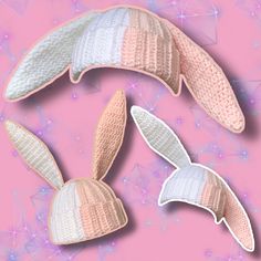 three knitted bunny ears are shown on a pink background