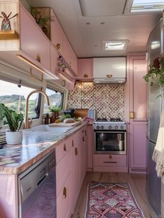 a kitchen with pink cabinets and an area rug