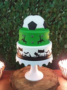 a three tiered cake with soccer themed frosting