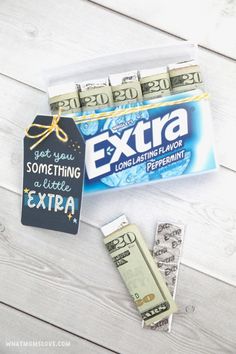 an extra money bag and some stickers on a white wooden table with the words extra next to it