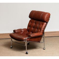 a brown leather recliner chair sitting on top of a carpeted floor next to a white wall