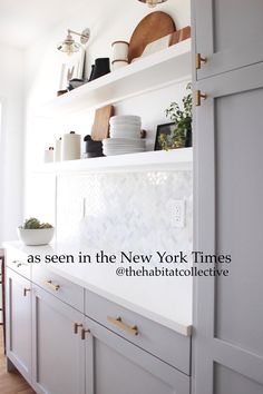 the shelves in this kitchen are filled with dishes