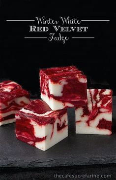 four pieces of red velvet fudge sitting on top of a black surface with the words, winter white red velvet fudge