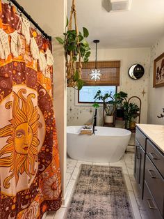 a bathroom with a sun shower curtain and rug