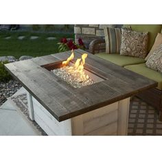 a fire pit sitting on top of a wooden table