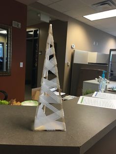 an office cubicle with a plastic christmas tree on the desk