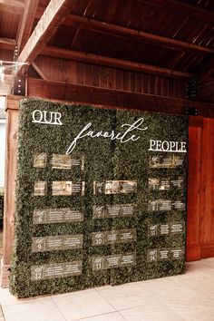 a sign that says our favorite people is on display in front of a wooden building