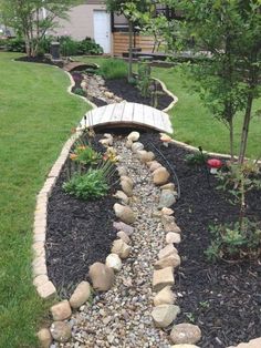 a garden with rocks and gravel in the middle