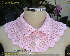 a pink crocheted collar on a mannequin