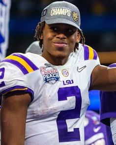 a close up of a football player wearing a hat and holding his arm out to the side