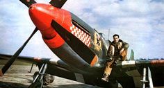 a man sitting on the wing of an airplane