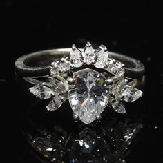 an engagement ring with pear shaped diamonds