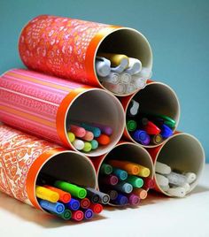 there are many different colored pencils in the tube on top of each other,