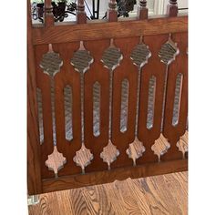 an old wooden fence with decorative ironwork on the sides and wood posts, in front of a window