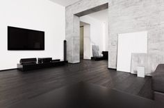 an empty room with black and white furniture