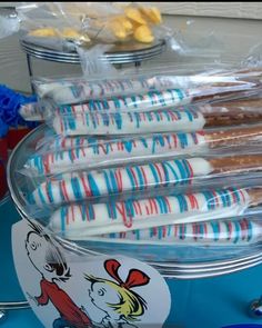 there are many different types of donuts on the table with plastic wrappers around them