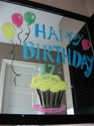 a happy birthday sign with cupcakes and balloons on the side of a door