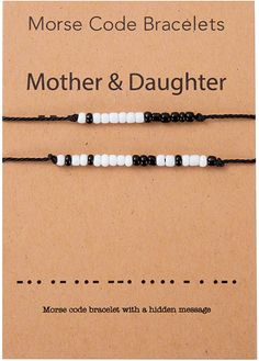 the mother and daughter bracelets are made with black, white and grey beads on cord