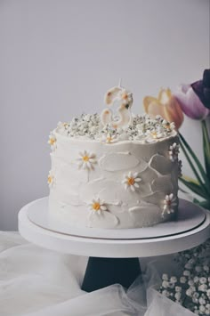 a white wedding cake with flowers on top