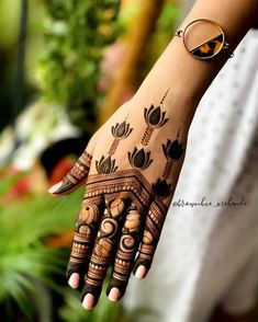 a woman's hand with hennap and rings on her fingers is shown