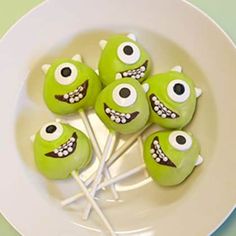 green monster lollipops on a white plate