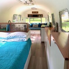 the interior of an airstream is clean and ready to be used as a bed