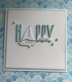 a happy birthday card with a sailboat and the words happy written in blue on it