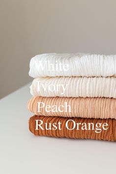 three different types of bedding stacked on top of each other with the words white ivory peach rust orange