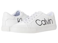 a white sneaker with black lettering on the side