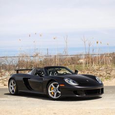 a black sports car is parked on the street