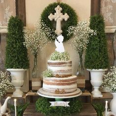 an image of a cake with white flowers on top and greenery around the edges