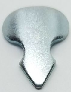 a silver metal object on a white surface