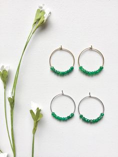 Emerald Hoop Earrings. Ten faceted emeralds adorn each hoop for a total of 20 emeralds in these beautiful earrings! These are perfect with jeans and a t-shirt or to wear with your best outfit! The hoops measure 1-1/4 inches in length and width or just over 3 cm. These earrings are available in either gold plated or rhodium plated finish. Emerald is the May birthstone. Your emerald hoop earrings will arrive gift boxed. If this is a gift, I would be glad to include a card with your personal messag Small Hoop Earrings With Faceted Beads For Gift, Small Hoop Jewelry With Faceted Beads For Gifts, Faceted Hoop Earrings As Gift, Gift Hoop Earrings With Faceted Beads, Faceted Beads Dangle Hoop Earrings For Gifts, Earrings Gold Hoop, Earrings Emerald, Hoop Earrings Silver, Hoop Earrings Gold