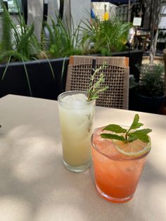 two drinks sitting on top of a table next to each other