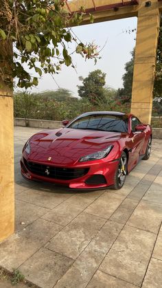 a red sports car parked in front of a building